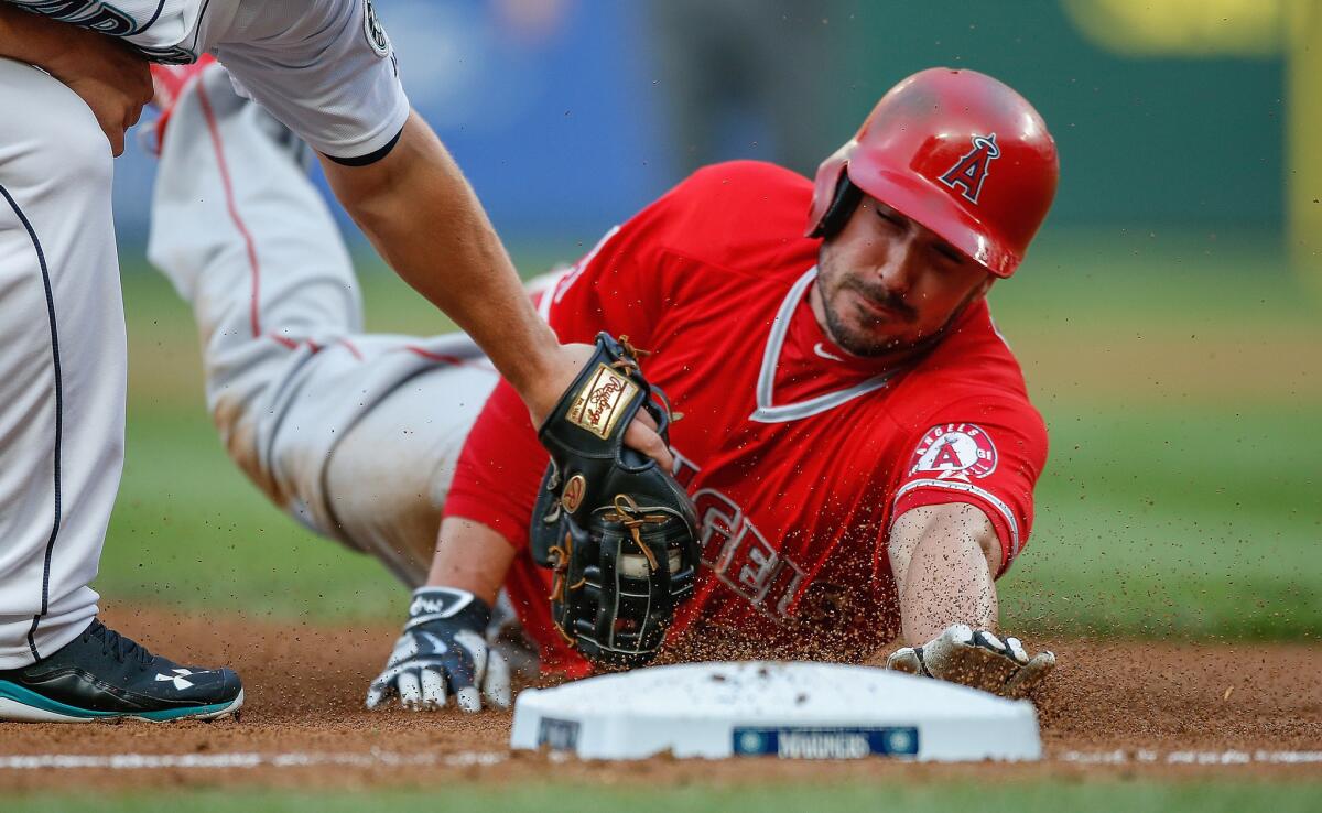 Angels outfielder Matt Joyce is tagged out at third base during a game against the Mariners. Joyce is the only MLB outfielder with at least 250 plate appearances batting below .200.