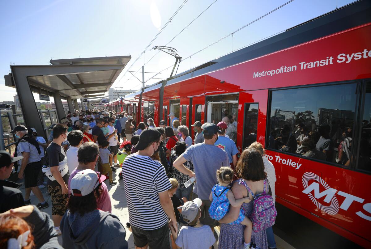 People board the Mid-Coast Extension of the UC San Diego Blue Line Trolley 