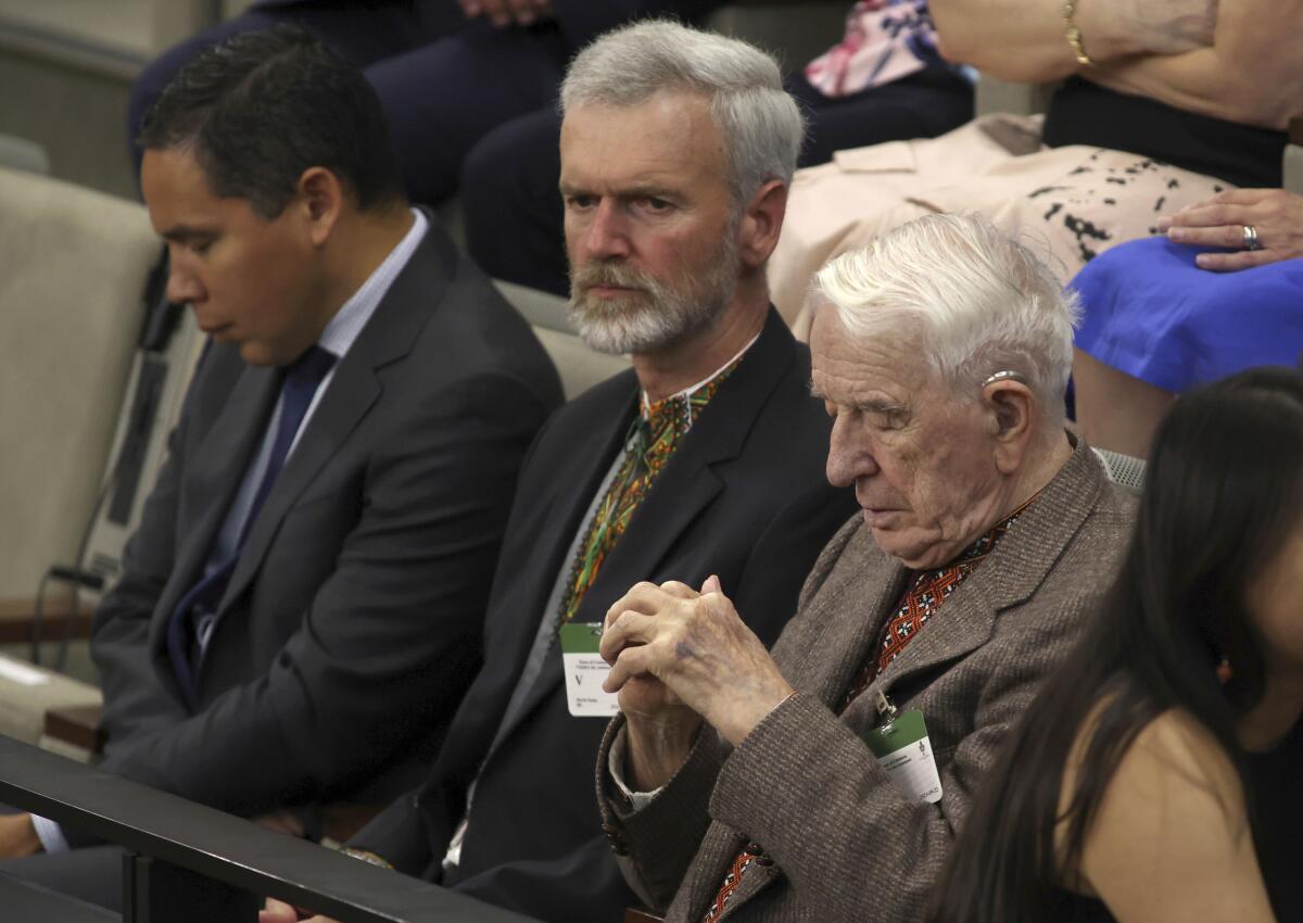 Three men attending a session of Canada's Parliament