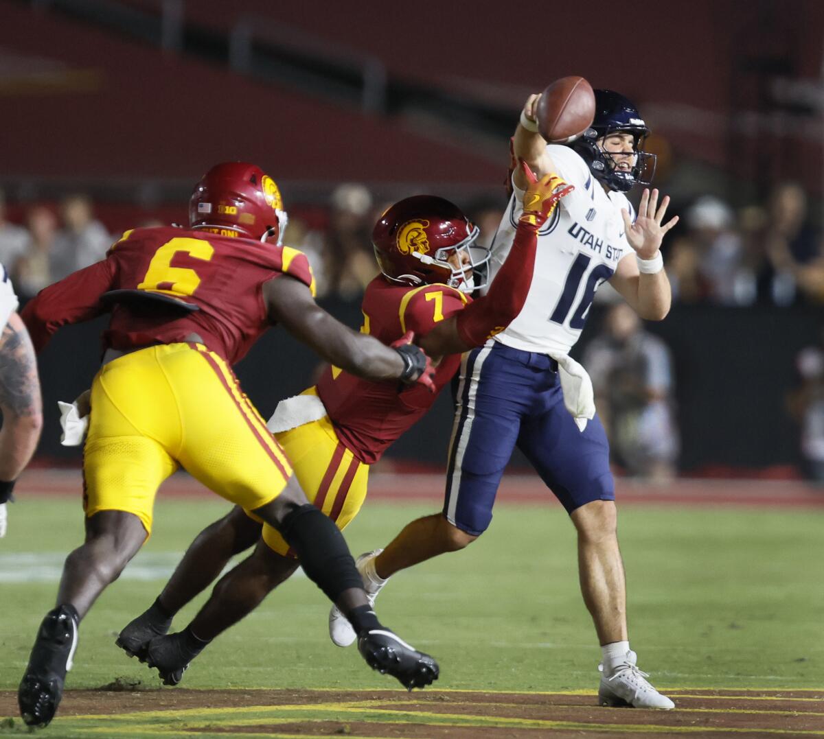 USC safety Kamari Ramsey knocks the ball out of the hands of Utah State quarterback Bryson Barnes at the Coliseum