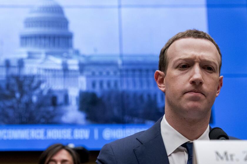 FILE - In this April 11, 2018, file photo, Facebook CEO Mark Zuckerberg pauses while testifying before a House Energy and Commerce hearing on Capitol Hill in Washington about the use of Facebook data to target American voters in the 2016 election and data privacy. Zuckerberg is calling for more outside regulation in several areas in which the social media site has run into problems over the past few years: harmful content, election integrity, privacy and data portability. (AP Photo/Andrew Harnik, File)