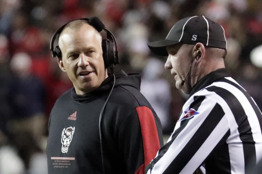 North Carolina State head coach Dave Doeren talks with an official.