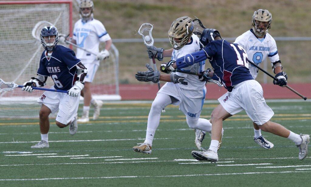 Corona del Mar's Nick Puglia is pressured by St. Margaret's Stuart Pollard in a U.S. Lacrosse Southern Section South Division semifinal on Saturday.