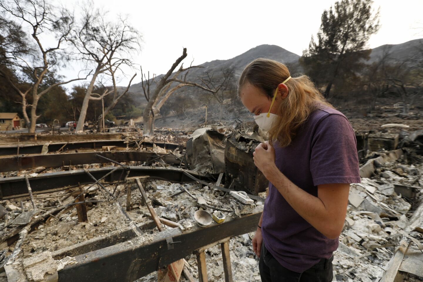 Garet Anzalone surveys his grandmother’s burned-out property in a mobile home park in Westlake Village.