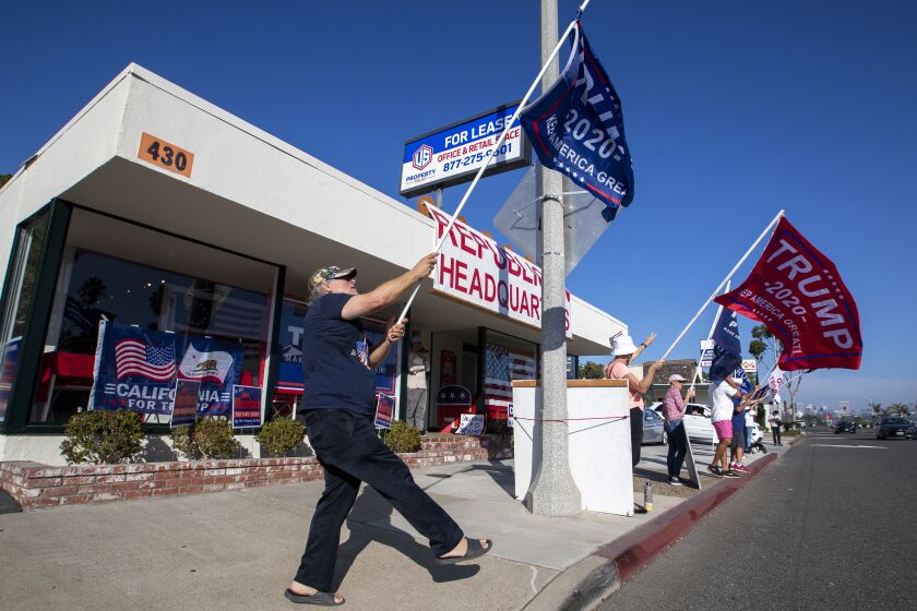 NEWPORT BEACH, CA - NOVEMBER 03: Pres. Trump supporter Steve Martin, left, of Westminster, joins fellow supporters as he dances and cheers on passing motorists in front of the Republican Party headquarters on election day Tuesday, Nov. 3, 2020 in Newport Beach. (Allen J. Schaben / Los Angeles Times)