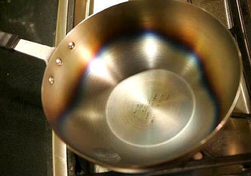 Heat wok until metal turns bluish-yellow.