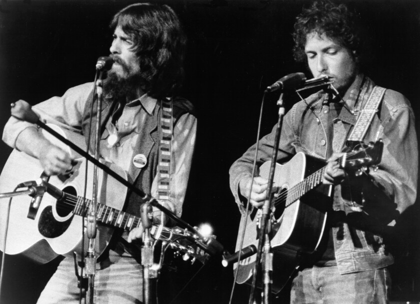 George Harrison (left) and Bob Dylan perform at the Concert for Bangladesh in 1971