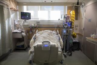 FULLERTON, CA - DECEMBER 25: A covid positive patient lays prone inside a negitive pressure room inside the ICU at Providence St. Jude Medical Center Christmas Day on Friday, Dec. 25, 2020 in Fullerton, CA. Patients with covid, or active TB, or shingles are placed in negitive preassure rooms when ever possible. Not every hospital have negitive preassure rooms. (Francine Orr / Los Angeles Times)
