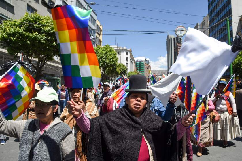 Supporters of Bolivian ex-President Evo Morales demonstrate holding Wiphala flags -representing native peoples- in La Paz on November 18, 2019. - Bolivia's interim president said Sunday she will call new elections soon, as the country struggles with violent unrest a week after the resignation of Evo Morales. (Photo by AIZAR RALDES / AFP) (Photo by AIZAR RALDES/AFP via Getty Images) ** OUTS - ELSENT, FPG, CM - OUTS * NM, PH, VA if sourced by CT, LA or MoD **