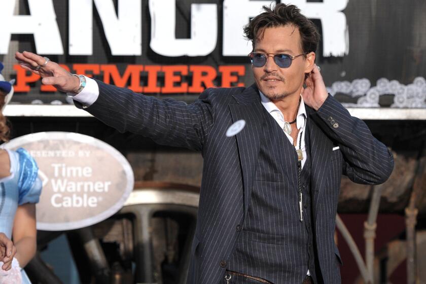 Johnny Depp appears on stage at the world premiere of "The Lone Ranger."