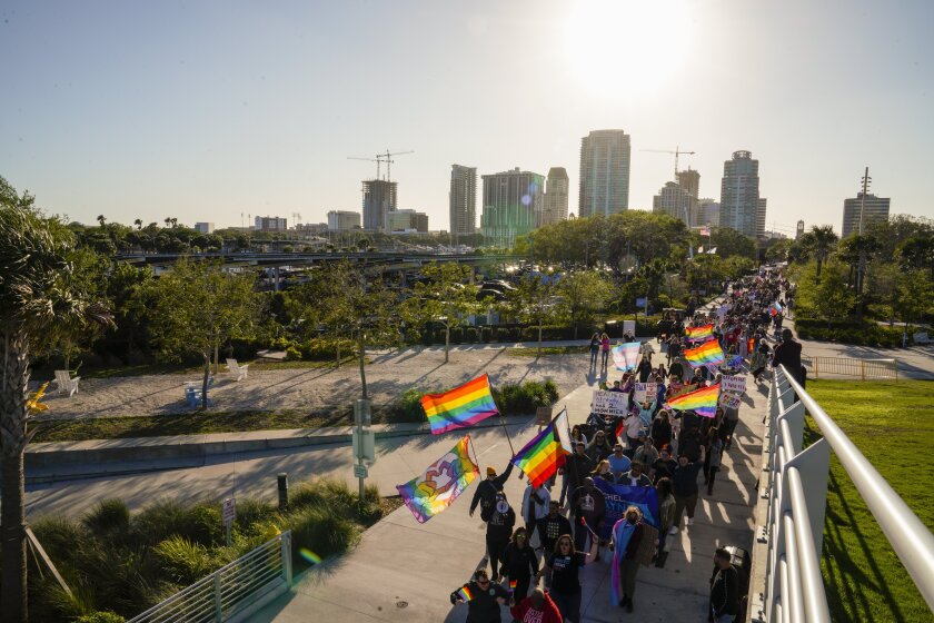 Marchers make their way toward the St. Pete Pier in St. Petersburg, Fla., on Saturday, March 12, 2022 during a march to protest the controversial "Don't say gay" bill passed by Florida's Republican-led legislature and now on its way to Gov. Ron DeSantis' desk. (Martha Asencio-Rhine/Tampa Bay Times via AP)