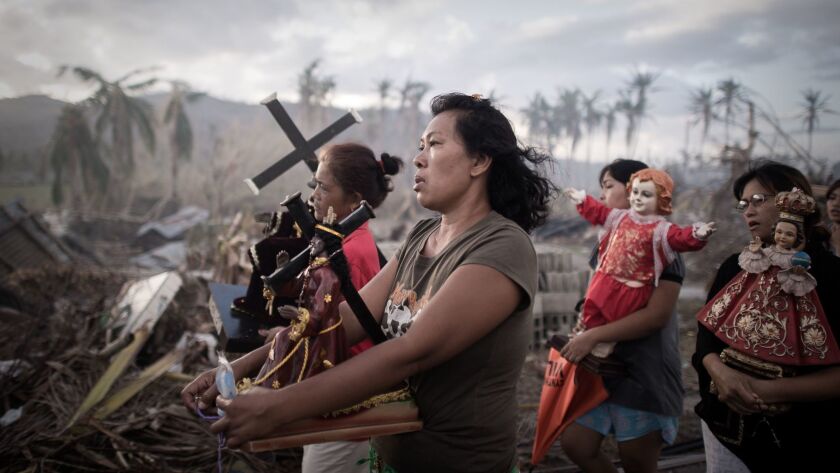 Survivors of Typhoon Haiyan take part in a religious procession in Tolosa, on the eastern Philippines island of Leyte, on Nov. 18, 2013.