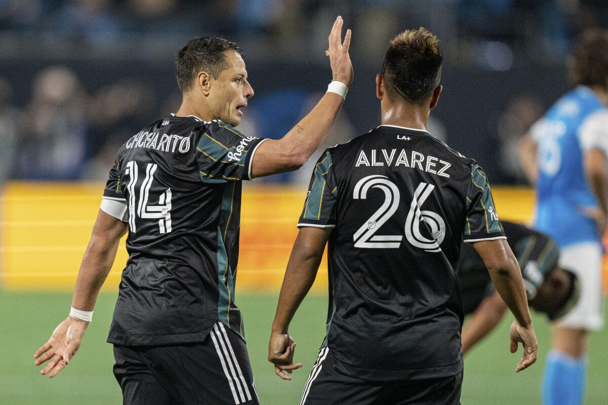 Galaxy forward Javier “Chicharito” Hernandez congratulates midfielder Efraín Álvarez during a match.