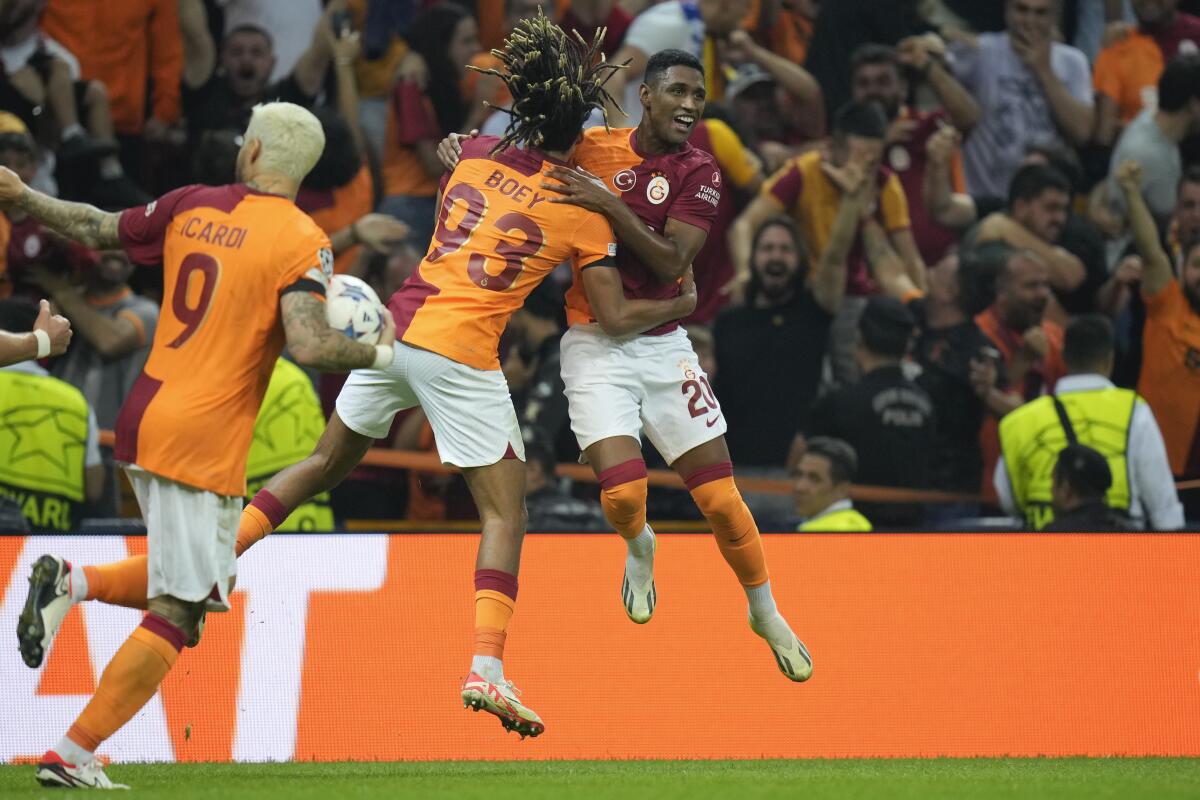 Galatasaray players celebrate with Galatasaray's Tete, right, who scored his side's second goal during their Champions League Group A soccer match between Galatasaray and FC Copenhagen in Istanbul, Turkey, Wednesday, Sept. 20, 2023. (AP Photo/Francisco Seco)