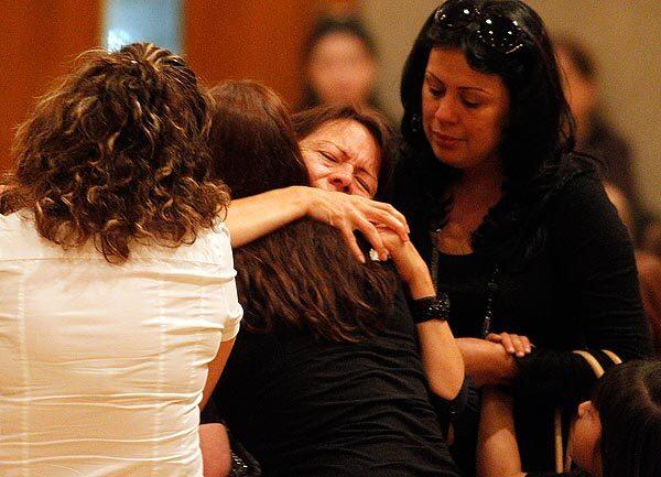 Family and friends comfort Margarita Meza, mother of Cindi Santana, during a South Gate memorial service for Cindi, a senior at South East High School who was stabbed to death on campus Sept. 30. Her ex-boyfriend, Abraham Lopez, 18, is in custody in the slaying. See full story