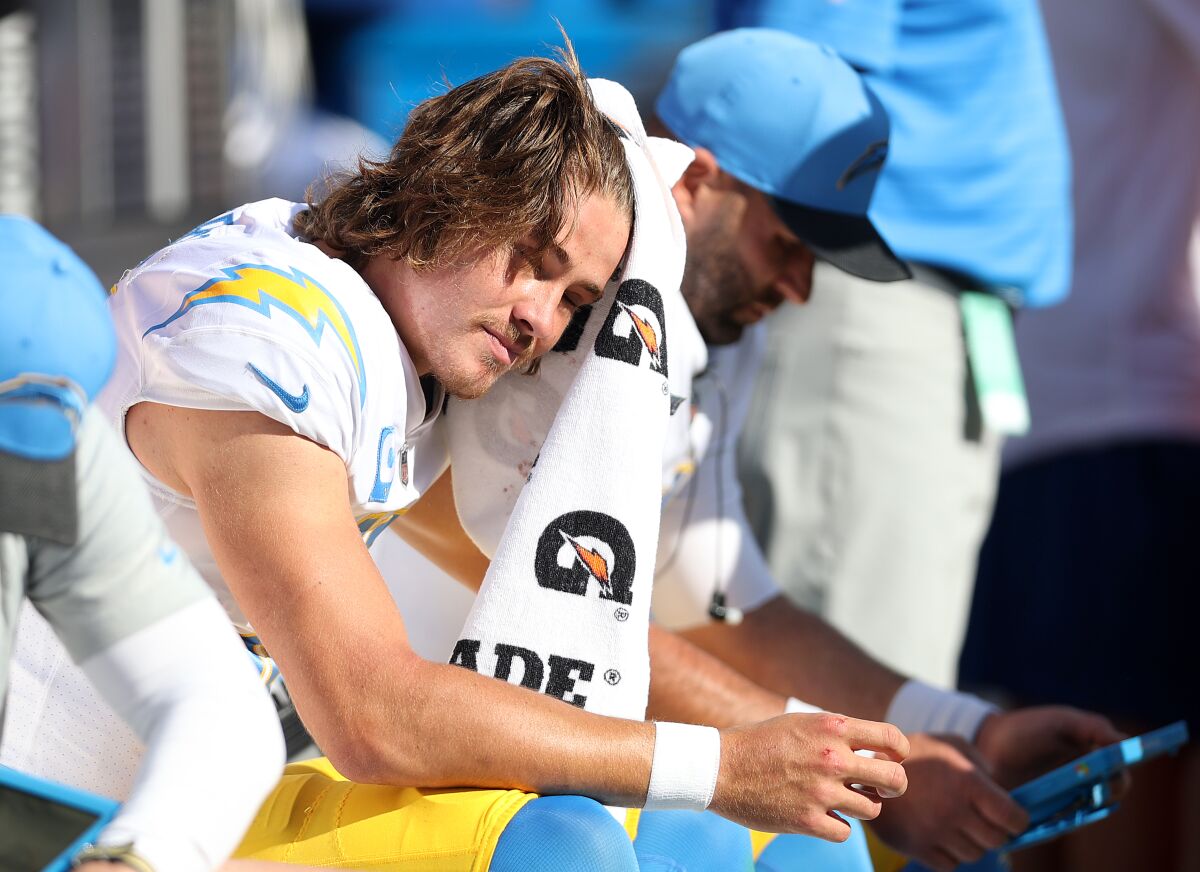 Chargers quarterack Justin Herbert looks on from the bench during a 34-6 loss to the Baltimore Ravens on Oct. 17.