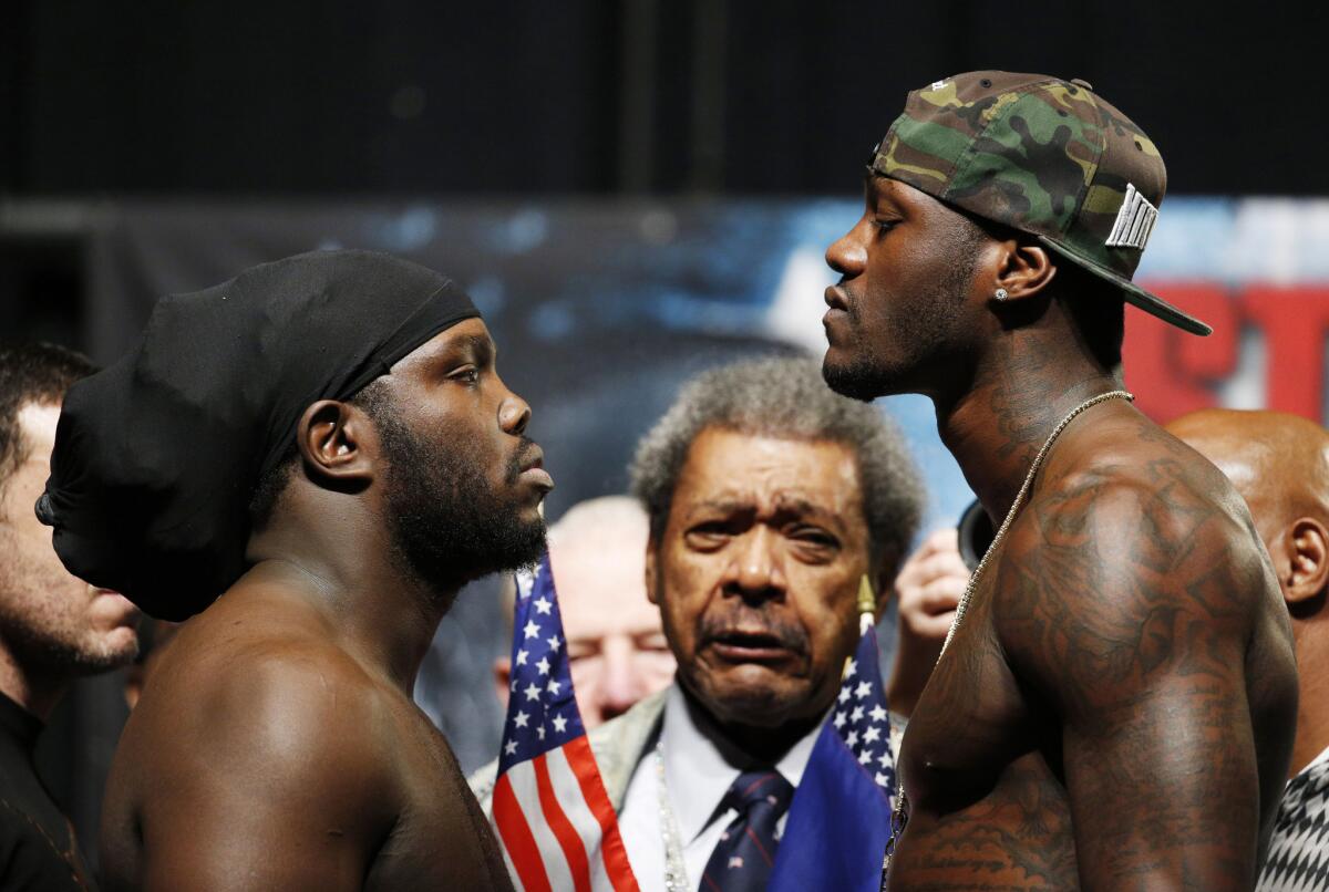 Heavyweights Bermane Stiverne and Deontay Wilder stare each other down at Friday's weigh-in for the WBC title fight in Las Vegas. Don King stands between the men in the background.