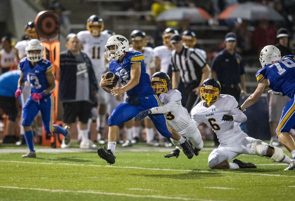 Fountain Valley's Abdel Habibeh is brought down by Marina's Jack Gladysz during a nonleague football game on Friday.