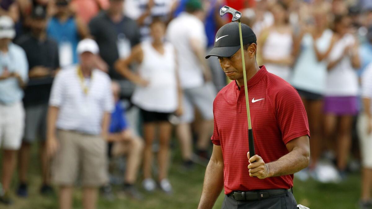 Tiger Woods walks off the 15th green Sunday during the final round of the PGA Championship at Bellerive Country Club in St. Louis.