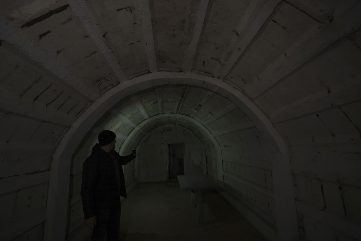 Tourist guide Afrim Cenaj, 44, shows the underground tunnels beneath the city of Kukes, about 150 kilometers (90 miles) north of Tirana, Albania, Wednesday, March 15, 2023. A new underground museum of tunnels built during the former communist regime to shelter residents in case of a war will serve Kukes, Albania’s poorest district, to attract tourists. (AP Photo/Franc Zhurda)