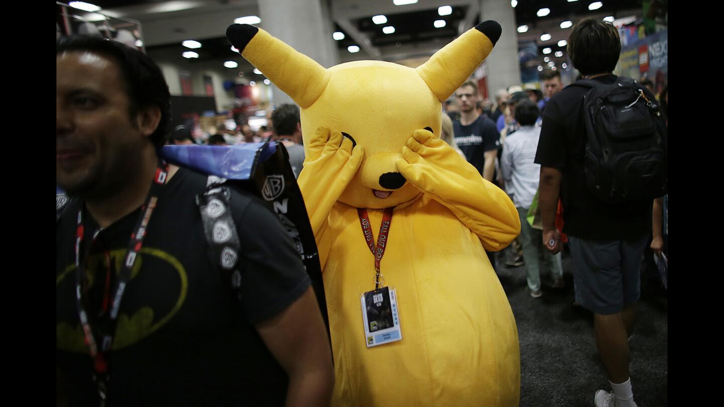 A peek-a-boo Pikachu walks through exhibition hall at the San Diego Convention Center during Comic-Con International.