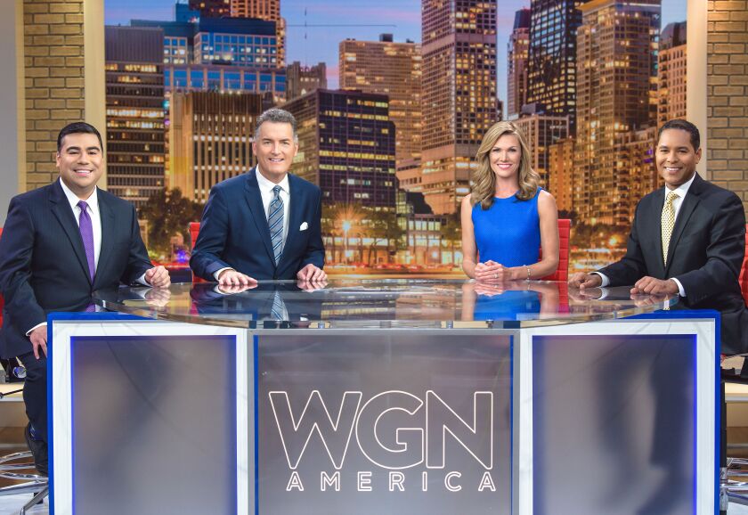 Four news anchors sit around a table that says "WGN America."