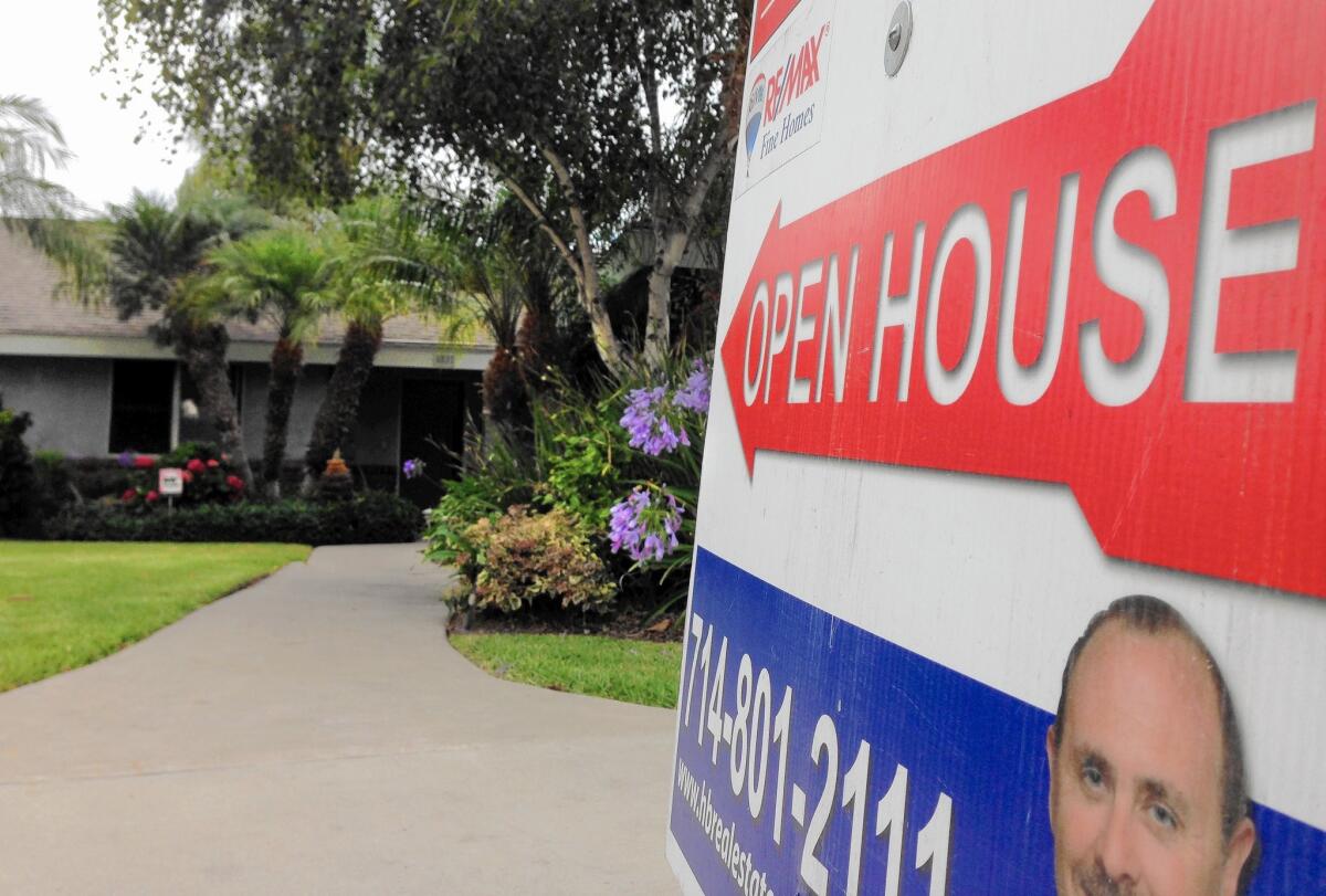 A sign advertises a home for sale in Huntington Beach.