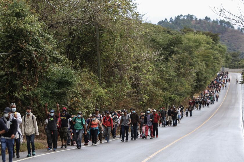 Migrants hoping to reach the U.S. border walk alongside a highway in Chiquimula, Guatemala, Saturday, Jan. 16, 2021. Honduran migrants pushed their way into Guatemala Friday night without registering, a portion of a larger migrant caravan that had left the Honduran city of San Pedro Sula before dawn, Guatemalan authorities said. (AP Photo/Delmer Martinez)