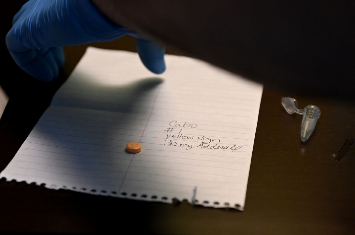 A pill is on a piece of paper.
