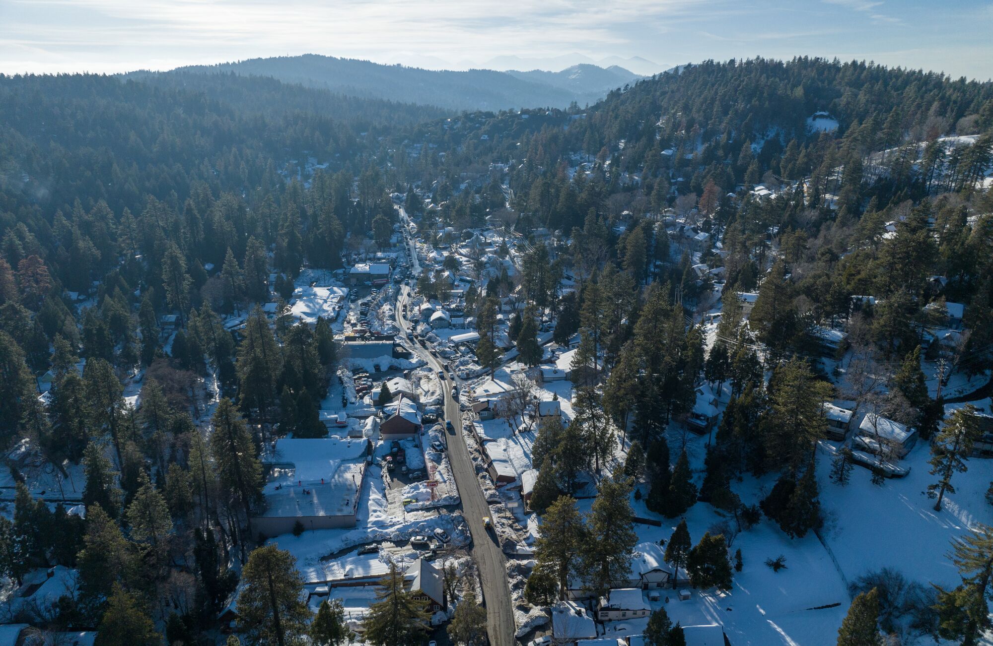 The community of Crestline continues to dig out after successive storms paralyzed the region.