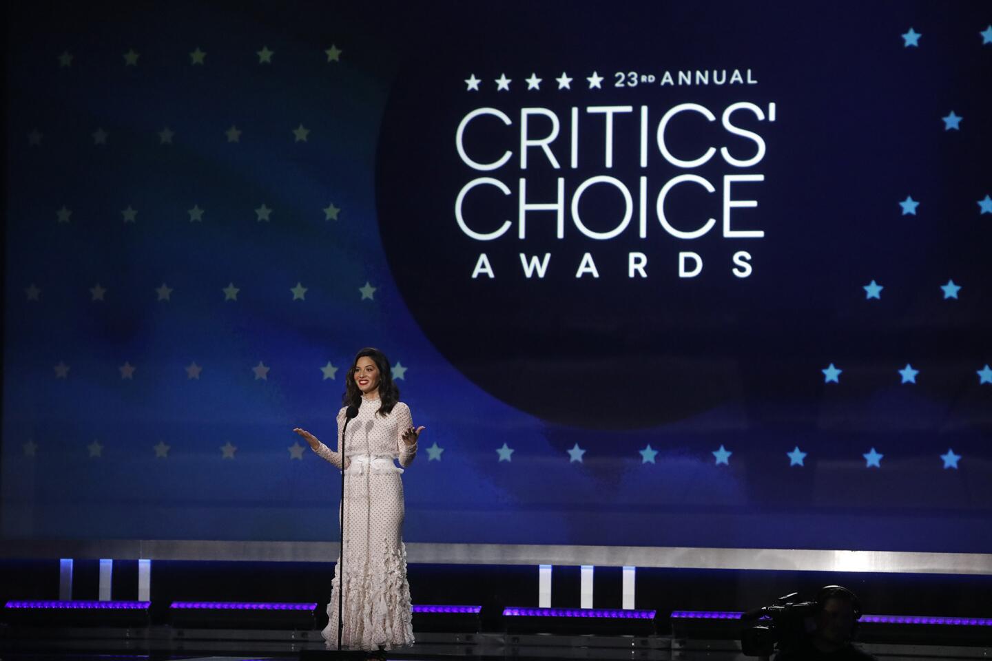 Actress Olivia Munn makes her introduction as host of the 23rd Critics' Choice Awards inside the Barker Hangar in Santa Monica.