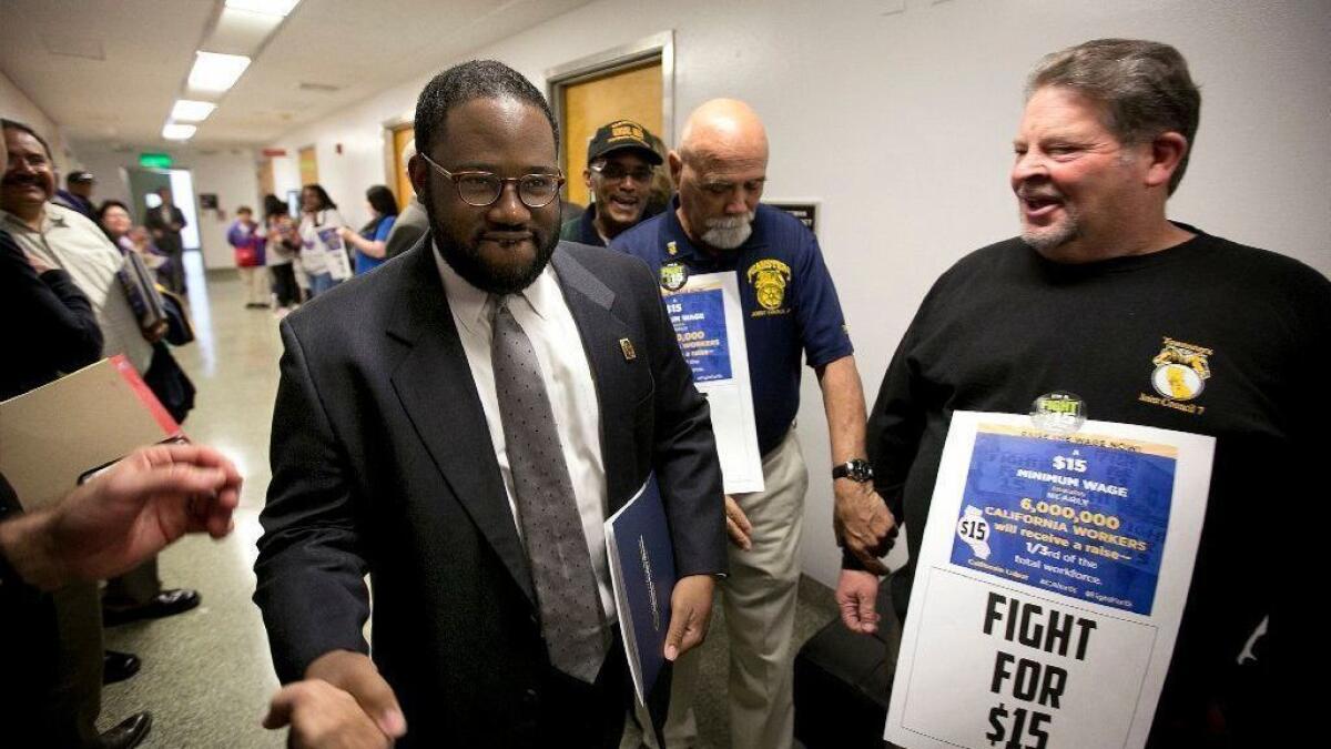 Then-Assemblyman Sebastian Ridley-Thomas (D-Los Angeles), center, is greeted by activists as he walks to the Assembly in Sacramento in 2016.