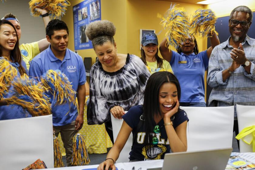 WESTWOOD, --APRIL 16, 2016-- Students and staff surround and cheer on Amora Haynes, center, from Vallejo, as she completes her Statement of Intent to Register (SIR) at UCLA, with her mom Wendy, left and dad Malik ( '76 alum), during Bruins Day, when the school welcomes to campus all admitted students for fall 2016 and pitches them on why they should accept the offer and enroll, in Westwood, CA, April 16, 2016. (Jay L. Clendenin / Los Angeles Times)