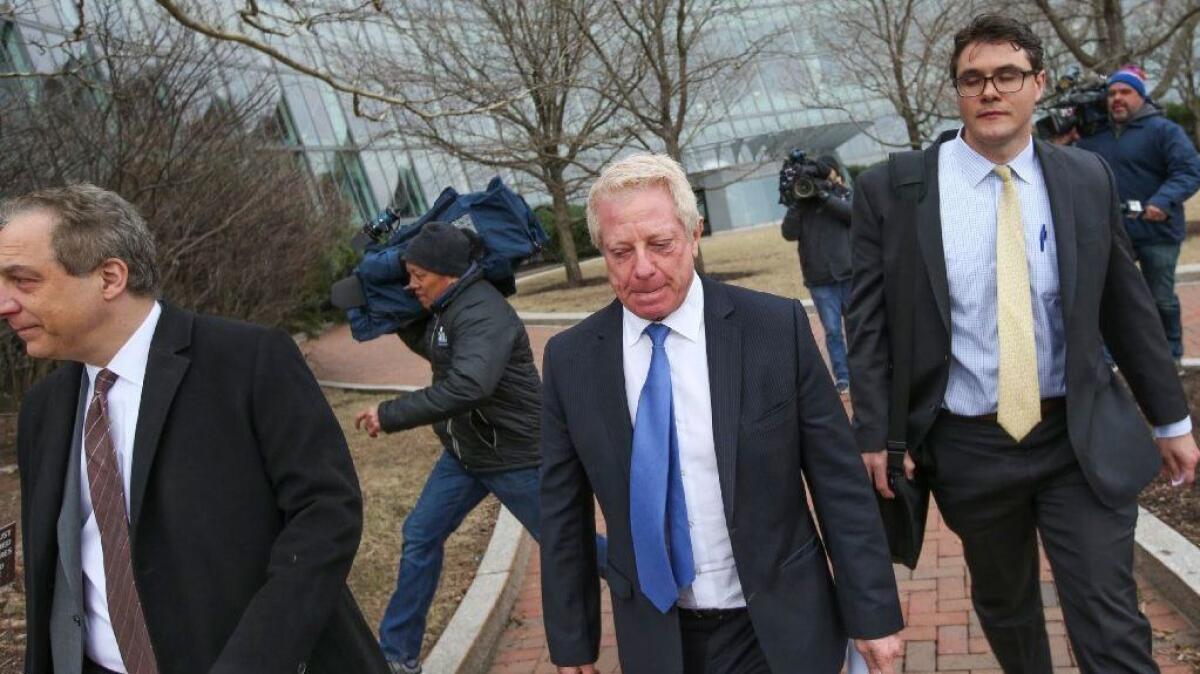 Robert Flaxman, center, of Laguna Beach, shown leaving the federal courthouse in Boston in March, pleaded guilty to fraud Friday along with Jane Buckingham and Marjorie Klapper in the college admissions scandal.