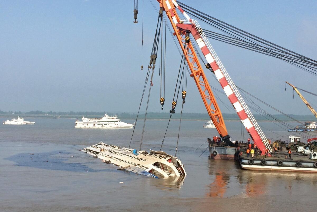 Cranes raise the sunken vessel Eastern Star in the Yangtze River in Jianli, central China's Hubei province.