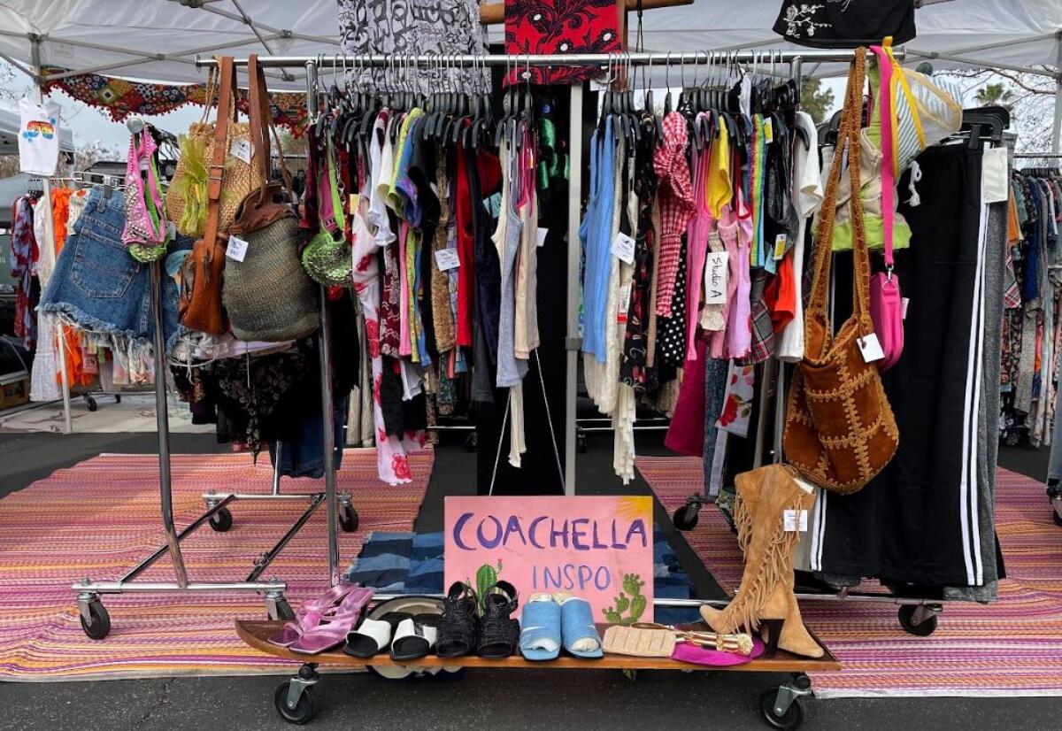 A clothing rack at an outdoor flea market 
