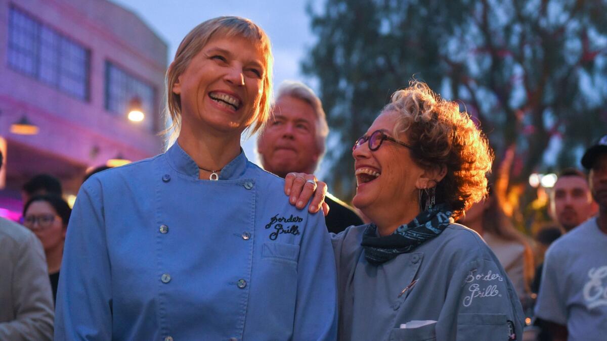 Mary Sue Milliken, left, and Susan Feniger of Border Grill share a laugh before being awarded the Los Angeles Times Gold Award at the second annual Food Bowl kickoff party on April 30.