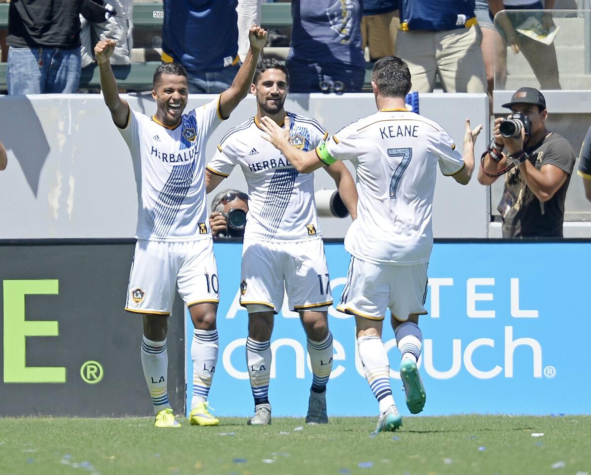 CARSON, CA - AUGUST 23: Giovani Dos Santos #10 of Los Angeles Galaxy celebrates his goal with teammates Robbie Keane #7 and Sebastian Lletget #17 against New York City FC during the second half at StubHub Center August 23, 2015, in Carson, California. (Photo by Kevork Djansezian/Getty Images) ** OUTS - ELSENT, FPG - OUTS * NM, PH, VA if sourced by CT, LA or MoD **