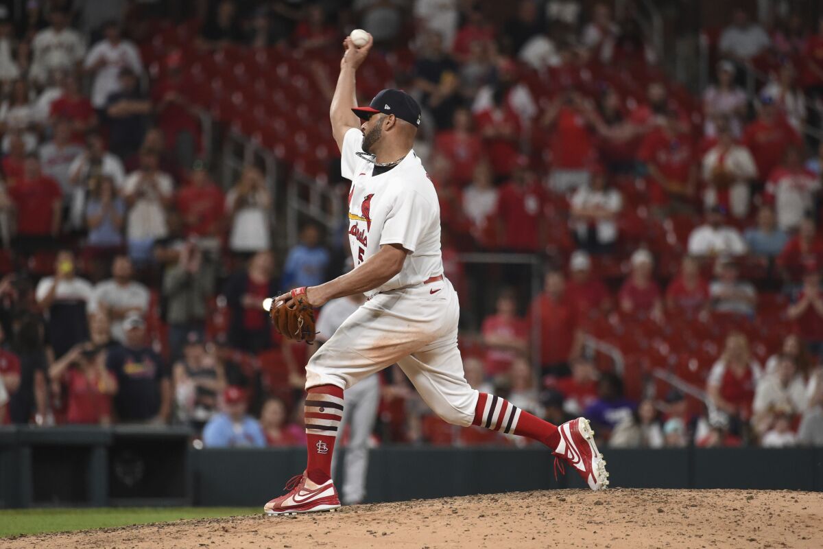 St. Louis Cardinals relief pitcher Albert Pujols (5) throws during the ninth inning of a baseball game against the San Francisco Giants on Sunday, May 15, 2022, in St. Louis. (AP Photo/Joe Puetz)