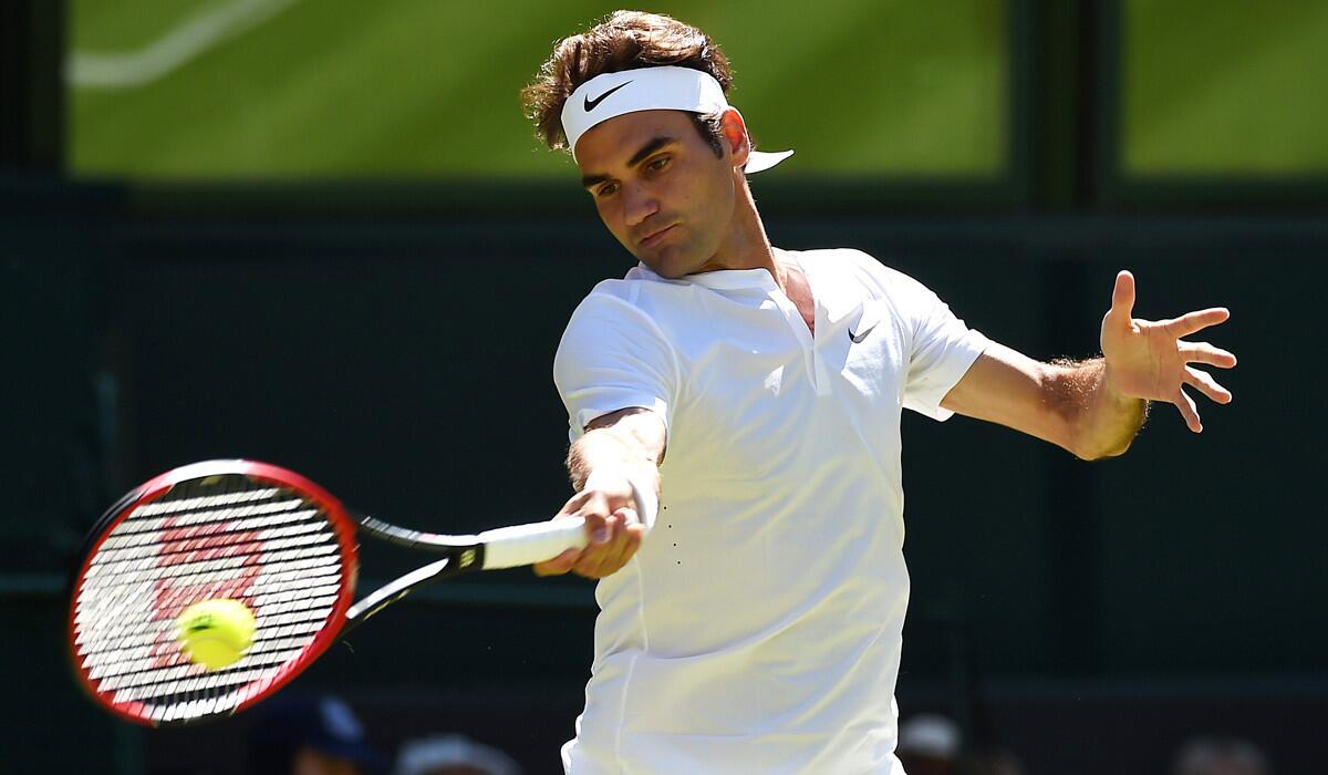 Roger Federer returns a serve to Damir Zumhur during a first round match at Wimbledon on Tuesday.