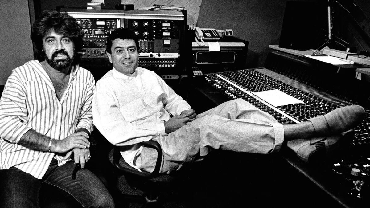 Shuki Levy, left, and Haim Saban, partners in Saban Productions, take a break in their Studio City sound studio in 1986.