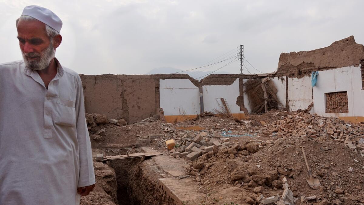 Shah Khan Kukikhel stands on the rubble of his brother's home near Jamrud, in the tribal areas of Pakistan.