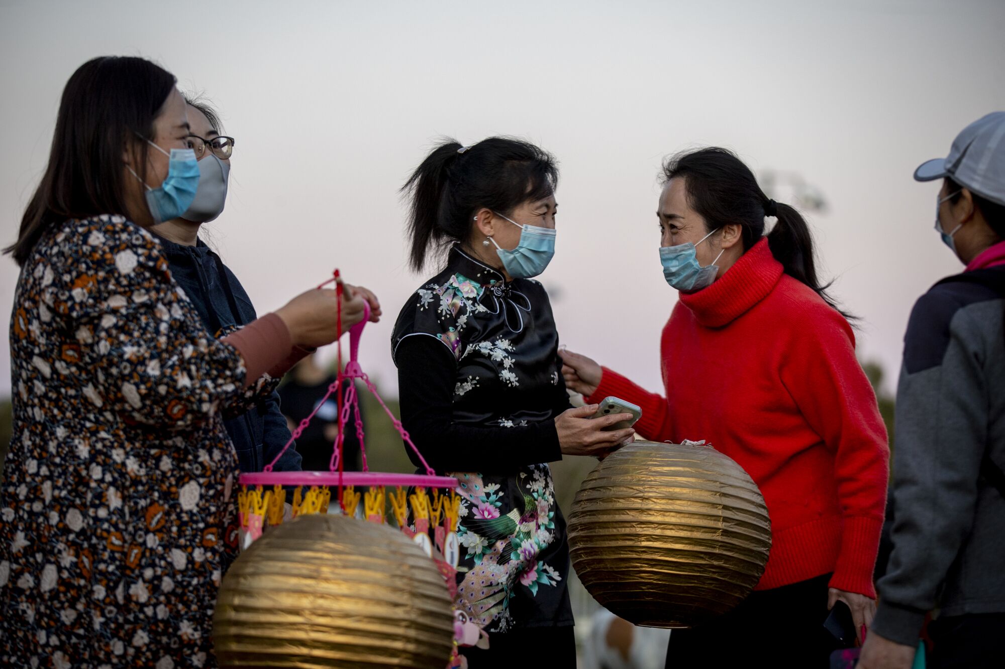People hold lanterns during a Lantern Festival of Hope, marking the last day of Lunar New Year