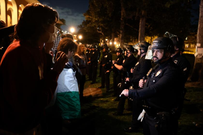 Los Angeles, CA - April 24: Los Angeles police officers stand a line with students protesting against the Israel-Palestinian war at the University of Southern California on Wednesday, April 24, 2024 in Los Angeles, CA.(Wally Skalij / Los Angeles Times)
