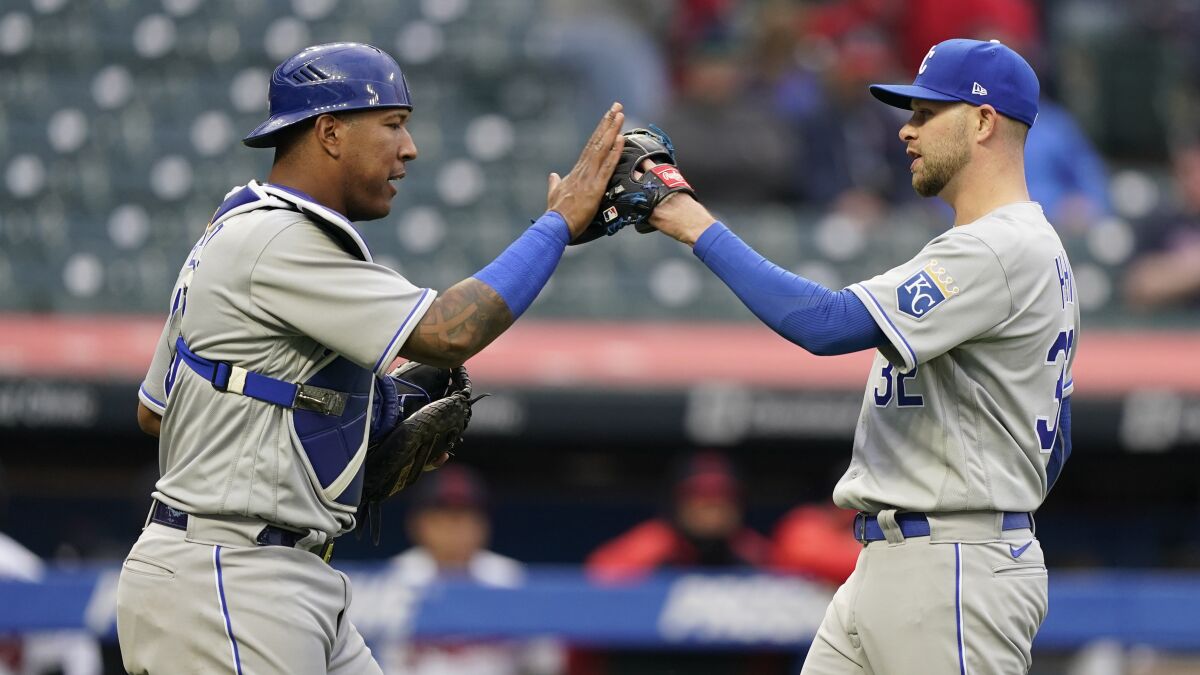Kansas City Royals relief pitcher Jesse Hahn, right, is congratulated by catcher Salvador Perez after a baseball game against the Cleveland Indians, Monday, April 5, 2021, in Cleveland. (AP Photo/Tony Dejak)