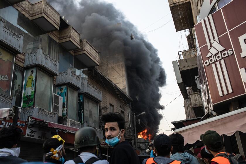 A building is set ablaze near Ahrar Bridge where there have been recent clashes between demonstrators and Iraq security forces on November 24, 2019 in Baghdad, Iraq. Thousands of demonstrators have occupied Baghdad's center Tahrir Square and central Baghdad since October 1, calling for government and policy reform.