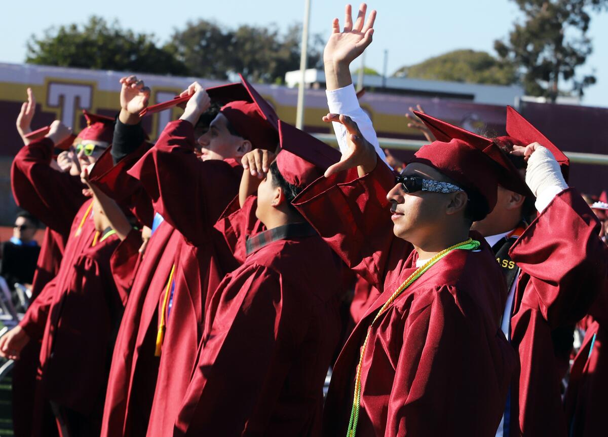 Graduates wave to their families and friends during the Ocean View graduation ceremony on Wednesday.