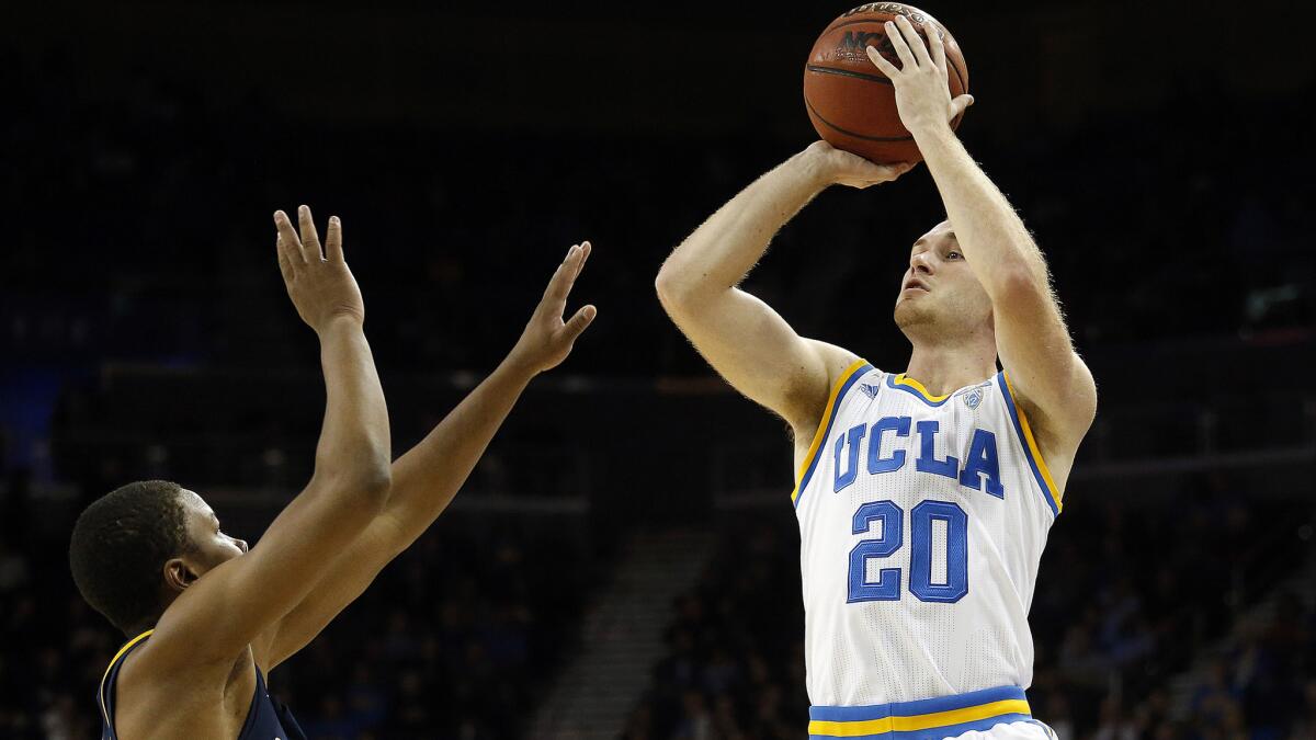 UCLA guard Bryce Alford takes a shot over California guard Charlie Moore during the first half Thursday night.