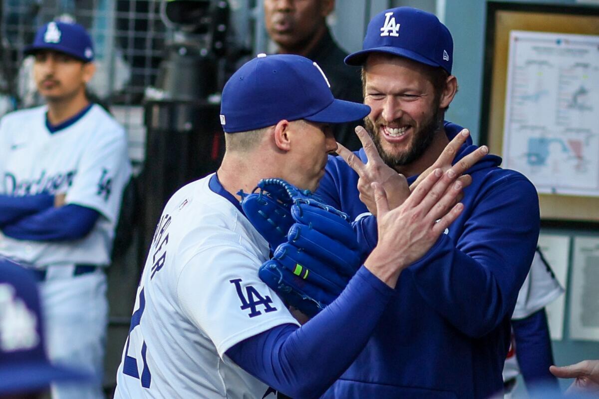 Dodgers pitcher Walker Buehler, left, gestures with Clayton Kershaw.