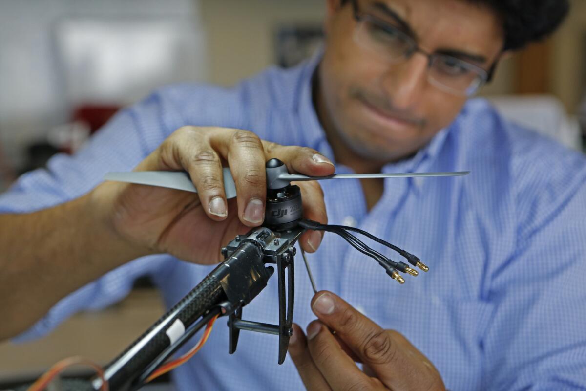 Brandon Angelo, chief executive of AwesomeSauce Labs, works on a drone at the USC Information Sciences Institute and Viterbi Startup Garage in Marina del Rey.